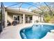 A gorgeous screened-in pool with covered patio and lounge area is ideal for enjoying the Florida lifestyle at 252 Longhirst Loop, Ocoee, FL 34761