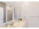 Bright bathroom featuring double sinks, quartz countertop, modern finishes, and a glass-enclosed shower at 257 Famagusta Dr, Davenport, FL 33896