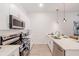 Modern kitchen featuring stainless steel appliances, white cabinetry, and elegant pendant lighting at 257 Famagusta Dr, Davenport, FL 33896