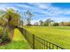 Expansive backyard bordering a golf course, featuring a manicured lawn and privacy fence at 2726 Babbitt Ave, Orlando, FL 32833