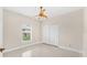 Cozy bedroom with a ceiling fan, window with blinds, neutral walls and a bright tile flooring at 2726 Babbitt Ave, Orlando, FL 32833