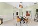 Dining area features a contemporary light fixture, table set for four, and sleek tile floors at 2726 Babbitt Ave, Orlando, FL 32833