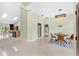 Open-concept dining area with modern light fixture, table set for four, and tile flooring at 2726 Babbitt Ave, Orlando, FL 32833