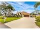 Attractive home featuring manicured lawn, mature trees, and a long driveway leading to a two-car garage at 2726 Babbitt Ave, Orlando, FL 32833