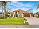 Beautiful one-story home boasts manicured lawn, decorative landscaping, and a two-car garage at 2726 Babbitt Ave, Orlando, FL 32833