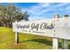 Wedgefield Golf Club sign, wooden, with blue skies and green grass around it at 2726 Babbitt Ave, Orlando, FL 32833