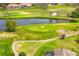 Scenic aerial view of the golf course with lush green fairways and a tranquil water feature at 2726 Babbitt Ave, Orlando, FL 32833