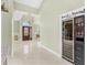 Hallway with wine fridge, tile flooring, and view of front door and dining area at 2726 Babbitt Ave, Orlando, FL 32833