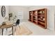 Office featuring a bookshelf, desk, chair, and a natural fiber rug. The walls are painted a neutral color at 2726 Babbitt Ave, Orlando, FL 32833