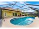 Backyard view of the kidney shaped swimming pool with screened in lanai and view of the house at 2726 Babbitt Ave, Orlando, FL 32833