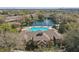 Aerial view of the exterior highlighting the roof, pool, lake, landscaping, and surrounding community at 2847 Metro Sevilla Dr # 103, Orlando, FL 32835