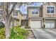 Charming townhome featuring an attached garage, manicured landscaping, and a welcoming facade at 2847 Metro Sevilla Dr # 103, Orlando, FL 32835