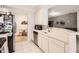 Galley kitchen featuring stainless steel appliances and a view into the dining area at 2847 Metro Sevilla Dr # 103, Orlando, FL 32835