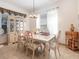 Bright dining room featuring a classic chandelier, elegant furnishings, and natural light at 3726 Mount Hope Loop, Leesburg, FL 34748