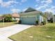 Inviting two-car garage with well-maintained lawn and established landscaping at 3726 Mount Hope Loop, Leesburg, FL 34748