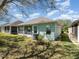 Back of the property showcasing the large yard, screened patio, and neutral color palette at 3726 Mount Hope Loop, Leesburg, FL 34748