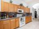 Well-lit kitchen featuring granite countertops, stainless steel appliances, and tile backsplash at 3726 Mount Hope Loop, Leesburg, FL 34748