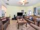 Cozy living space featuring a ceiling fan, tile flooring, and a comfortable seating area at 3726 Mount Hope Loop, Leesburg, FL 34748