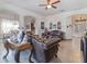 Inviting living area with tile flooring, a ceiling fan, and a view of the dining area at 3726 Mount Hope Loop, Leesburg, FL 34748