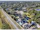 An aerial view of a community with a winding road, trees, and residential homes that have a mix of yard sizes at 380 Morning Glory Dr, Lake Mary, FL 32746