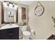 Cozy bathroom with a framed mirror, black vanity, and decorative wall hangings at 380 Morning Glory Dr, Lake Mary, FL 32746