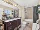 Bathroom with a large mirror, vanity, bathtub, tiled shower and decorative accents at 380 Morning Glory Dr, Lake Mary, FL 32746