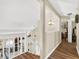 Hallway with wood floors and view of the kitchen and living room at 380 Morning Glory Dr, Lake Mary, FL 32746