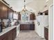 Well-lit kitchen features dark wood cabinets, granite countertops, and stainless steel appliances at 380 Morning Glory Dr, Lake Mary, FL 32746