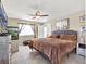 Bedroom with comfortable bed, ceiling fan, tiled floors, and an aquarium at 380 Morning Glory Dr, Lake Mary, FL 32746