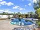 Private swimming pool with an adjacent spa, landscaping, and sunny skies at 380 Morning Glory Dr, Lake Mary, FL 32746