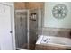 Elegant bathroom featuring a glass-enclosed shower, soaking tub, and stylish tile work at 4110 Arlington Ridge Blvd, Leesburg, FL 34748