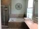Luxurious bathroom complete with a separate shower, soaking tub, and modern fixtures at 4110 Arlington Ridge Blvd, Leesburg, FL 34748