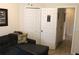 Bedroom featuring a comfortable gray sofa and closet, next to doorway leading into hallway at 4110 Arlington Ridge Blvd, Leesburg, FL 34748