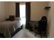 Comfortable bedroom with a bed, dark curtains and a gaming chair at 4110 Arlington Ridge Blvd, Leesburg, FL 34748