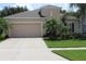 Charming home featuring a well-manicured lawn, attractive landscaping, and a spacious two-car garage at 4110 Arlington Ridge Blvd, Leesburg, FL 34748