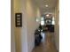 Hallway leads to a living room with furniture, decor and tile flooring at 4110 Arlington Ridge Blvd, Leesburg, FL 34748