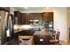 Modern kitchen featuring granite countertops, stainless steel appliances and an island with seating at 4110 Arlington Ridge Blvd, Leesburg, FL 34748