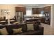 Open-concept living area shows kitchen with granite counters and stainless appliances next to Gathering room at 4110 Arlington Ridge Blvd, Leesburg, FL 34748