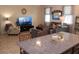 Inviting living area with neutral colors, comfortable seating, and natural light, adjacent to kitchen at 4110 Arlington Ridge Blvd, Leesburg, FL 34748