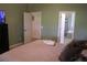 Comfortable bedroom with neutral colors, adjacent to an en-suite bathroom, with a view of a walk-in closet at 4110 Arlington Ridge Blvd, Leesburg, FL 34748