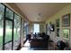 Spacious screened-in patio with comfortable seating, dining area, and scenic backyard views at 4110 Arlington Ridge Blvd, Leesburg, FL 34748