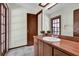 This bathroom features wood cabinets, a large mirror, and neutral paint at 414 Sundown Trl, Casselberry, FL 32707