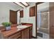 This bathroom features wood cabinets, a large mirror, and a shower/tub combo at 414 Sundown Trl, Casselberry, FL 32707