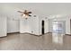 Spacious living room featuring neutral tile flooring, a ceiling fan, and sliding glass doors to the lanai at 414 Sundown Trl, Casselberry, FL 32707