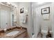 Well-lit bathroom featuring a granite-top vanity and a shower-tub combination with a white curtain at 4376 Lake Underhill Rd # C, Orlando, FL 32803