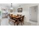 Dining area with wood table and bench, complemented by a view into the adjacent, well-lit kitchen at 4376 Lake Underhill Rd # C, Orlando, FL 32803