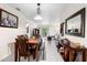 Open-concept dining area with wooden table, bench seating, stylish decor, and a view into the living room at 4376 Lake Underhill Rd # C, Orlando, FL 32803