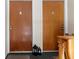 Hallway featuring two apartment doors, labeled 'C' and 'D', with vintage-style hardware and lighting at 4376 Lake Underhill Rd # C, Orlando, FL 32803