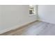 Bedroom featuring attractive gray wood-look flooring, window, and crisp white walls at 4415 Sw 169Th Lane Rd, Ocala, FL 34473