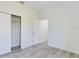 Bedroom with closet and gray wood-look flooring and crisp white walls and trim at 4415 Sw 169Th Lane Rd, Ocala, FL 34473